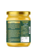 Jar of cow ghee with a green label on a white background