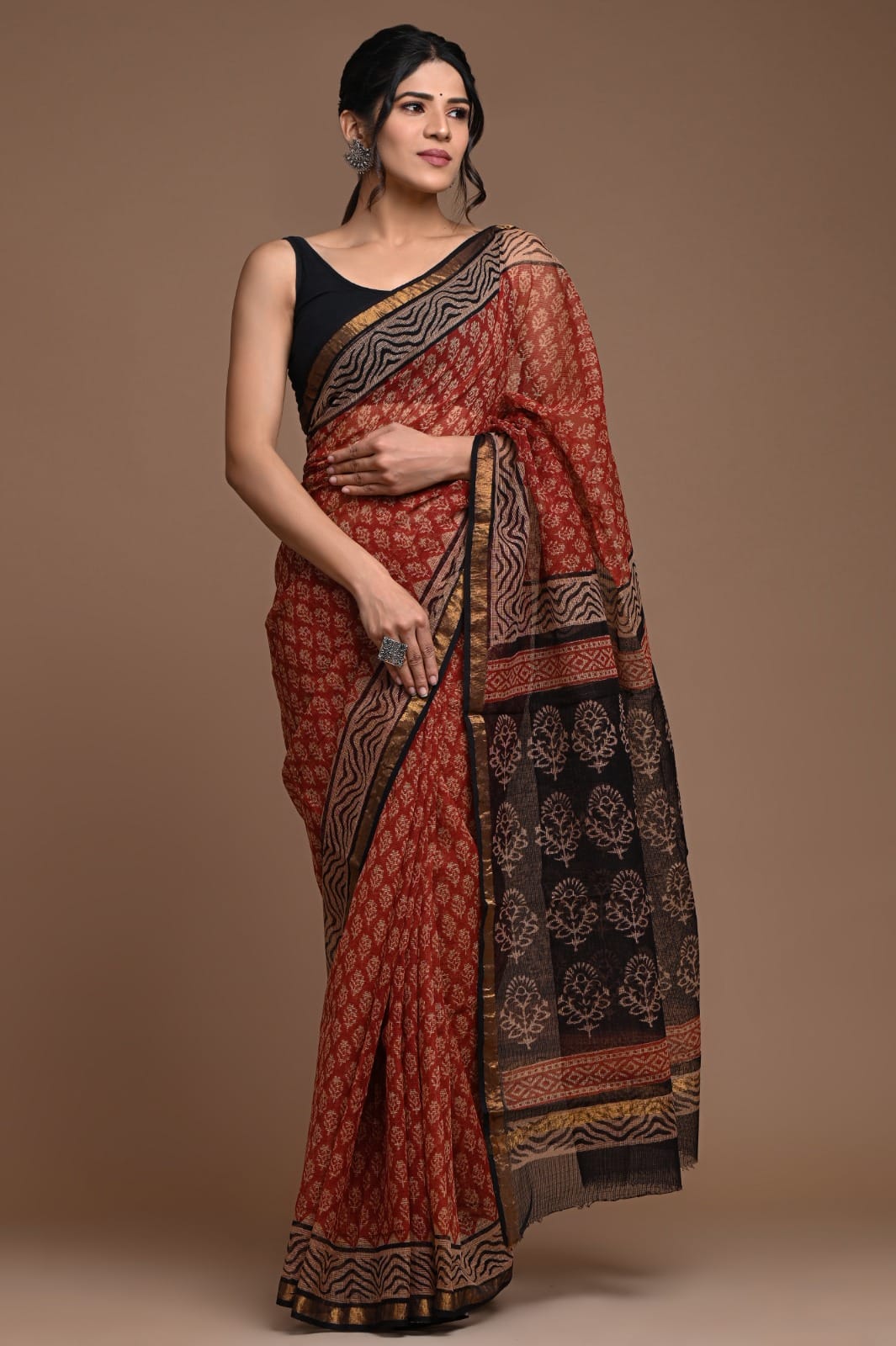 Woman wearing a traditional saree with a brown background
